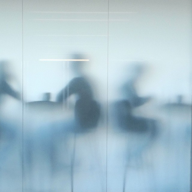 Silhouettes of people seen through the translucent café windows at Tate Modern.