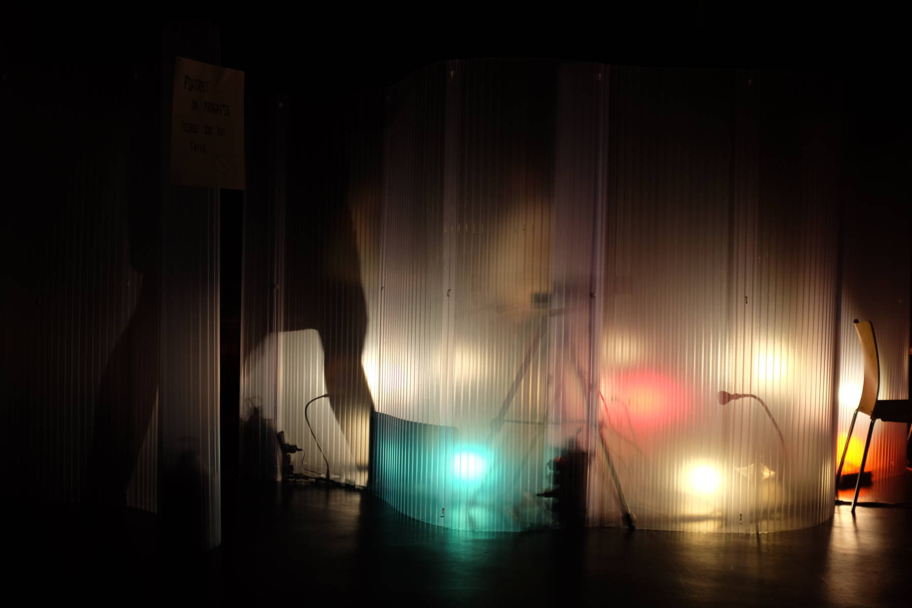 A Movement Alphabet participant's silhouette is seen from the outside of the interaction pod - Movement Alphabet by Jan Lee and Tim Murray Browne - taken at Watermans Arts Centre